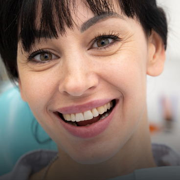 dentist examining patient teeth with mouth mirror