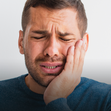 dentist examining patient teeth with mouth mirror